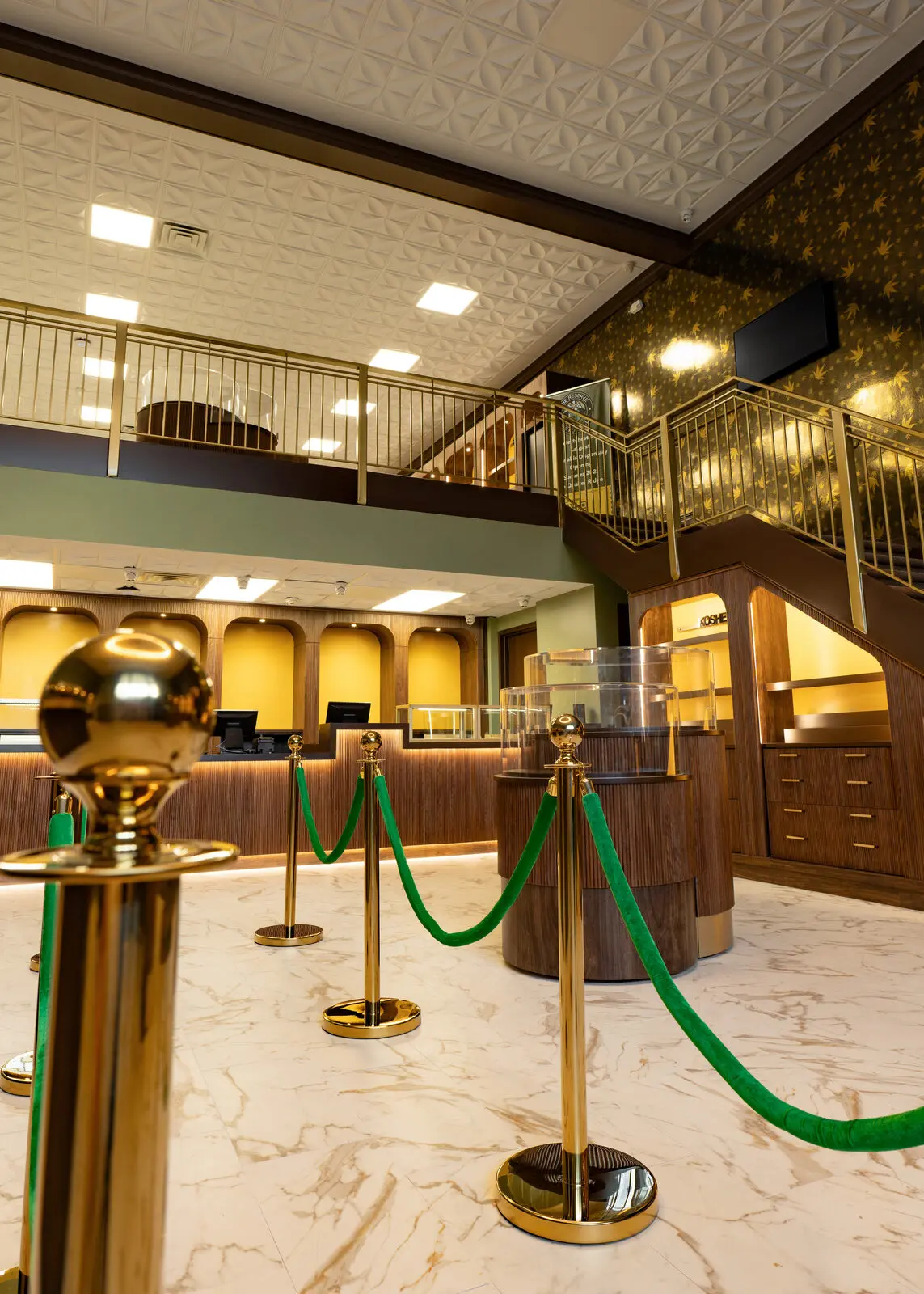 The Reserve lobby with marble floors, brass rails and green velvet ropes